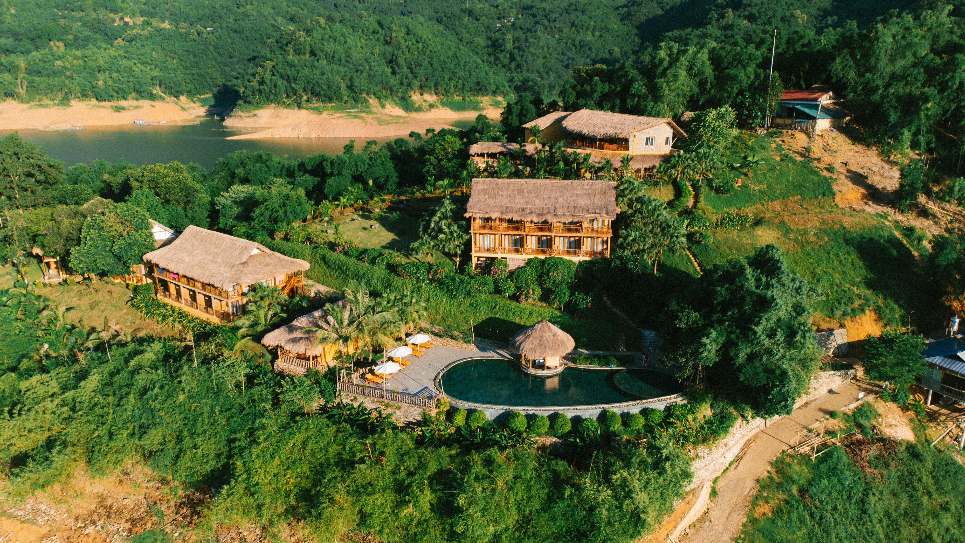 Unwind at Mai Chau Hideaway Lake Resort after a day of trekking in Pu Luong 