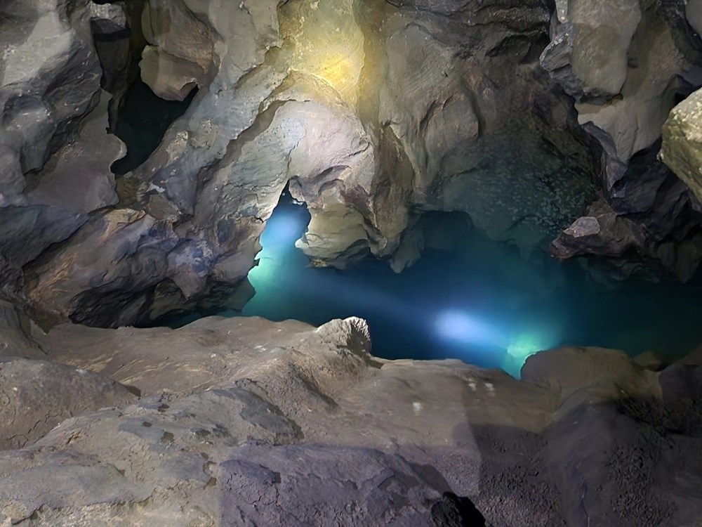 Water draining through the cave floor is part of a 2.5-kilometer underground river system connecting to Pon Village (Source: VOV)