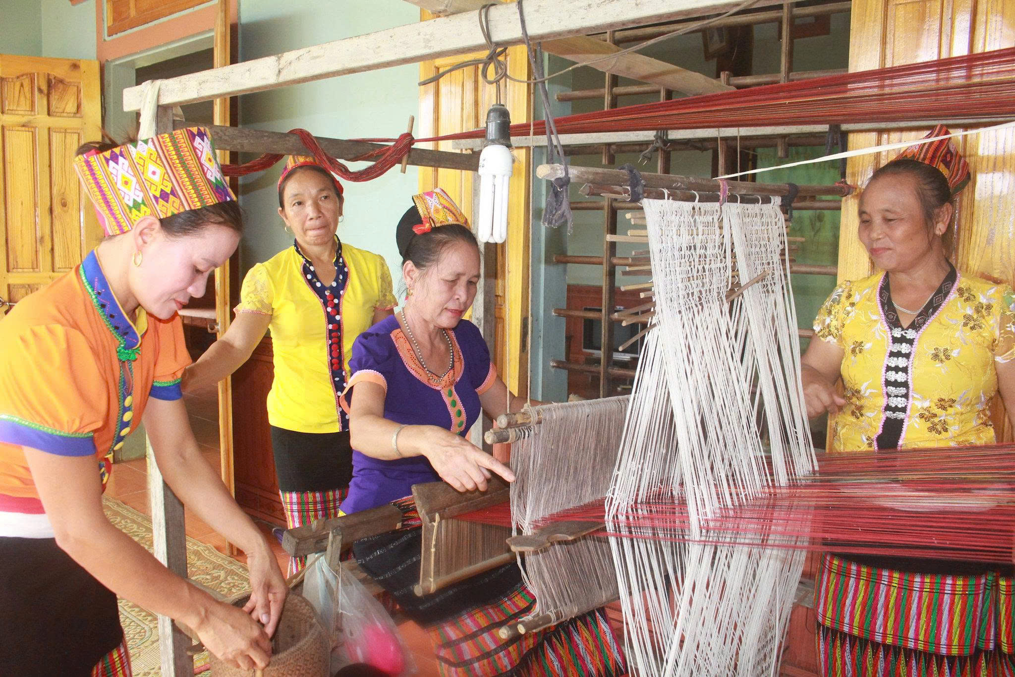 Thai woman weaving traditional brocade in But Village
